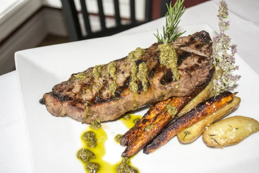   Prime New York Strip Steak ($42) served with rosemary parmesan fingerling potatoes, roasted baby carrots and a chimichurri drizzle.  