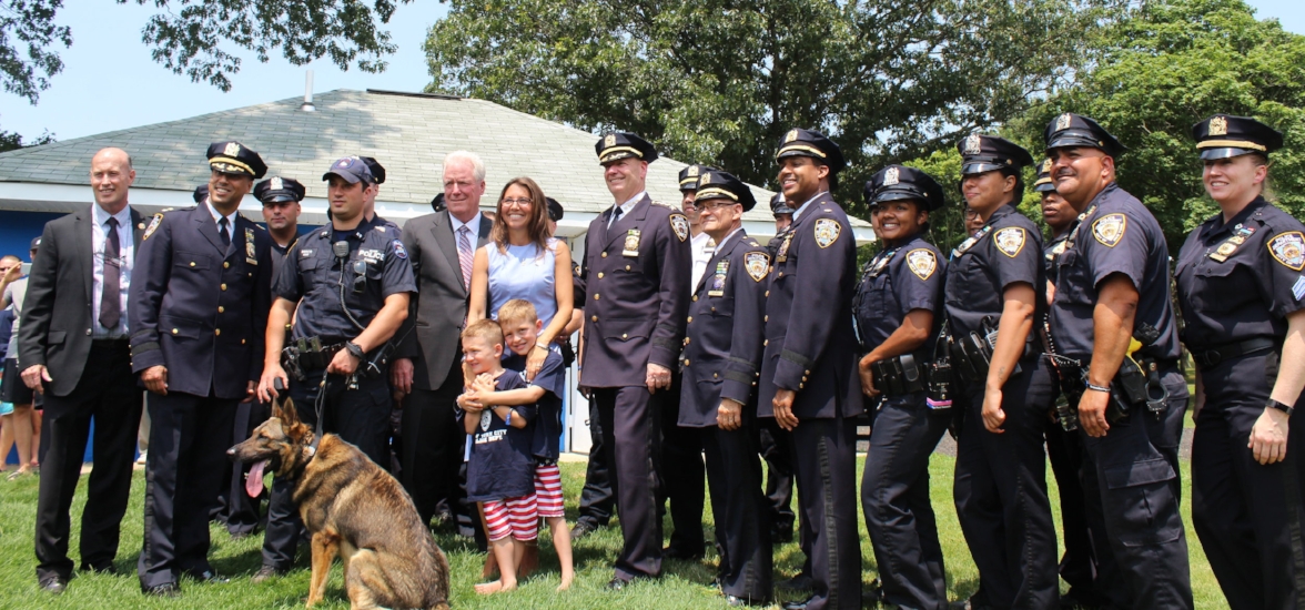   Lisa Tuozzolo and sons Austin and Joseph are flanked by members of the Suffolk Police Department.  