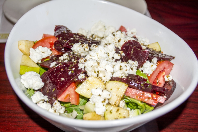   Mykonos Salad ($12) features mixed greens, cucumber, tomato, onion, goat cheese, beets, granny smith apple and candied walnuts.    