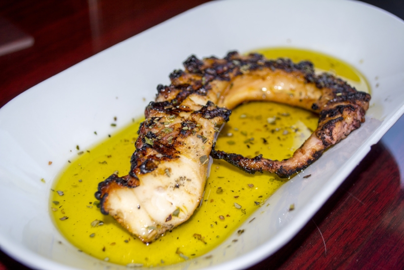   Grilled Octopus ($18) features lightly char-grilled baby octopus drizzled with olive oil and oregano.    