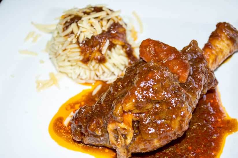   Lamb Shank ($20) is served with a side of orzo and topped with red sauce.    