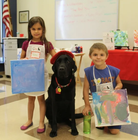  Siblings Emma, 5, and Thomas Pandolfi, 7, show of their paintings with DogVinci.    