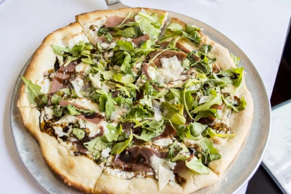   Arugula Pizzetta ($15) features fresh mozzarella, prosciutto and a balsamic reduction.   (Long Islander News photos/Connor Beach)  