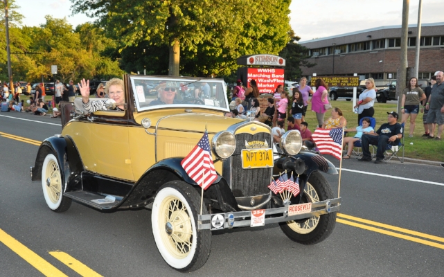   Huntington Town Clerk Jo-Ann Raia rides in an antique car.  