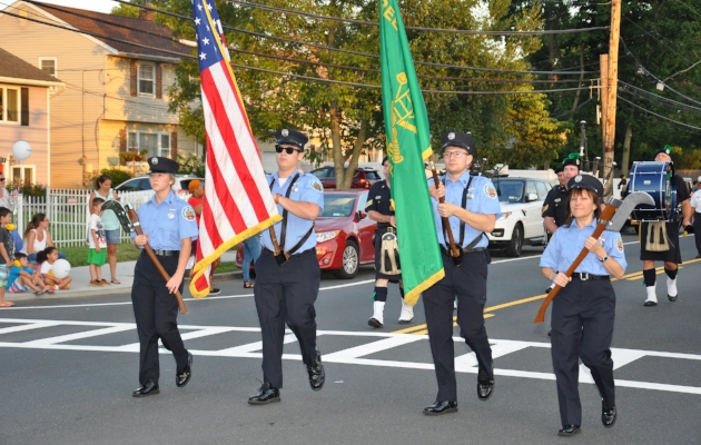   The Greenlawn Fire Department Color Guard marches.  