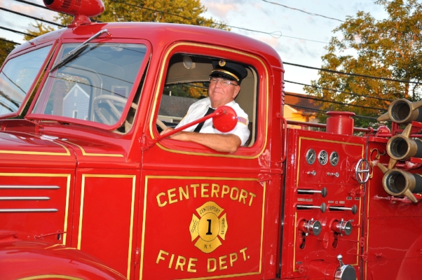   Centerport ex-Chief Jim Feeley at the wheel of the department’s antique truck.  