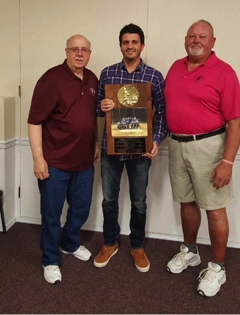 Huntington Softball Hall of Fame President James Coschignano Jr., left, and Vice President Clint Riggs, right, present SPS Nation sponsor and player Mike Ruconich, center, with a plaque for winning Division 2 in the Town of Huntington recreation softball league.