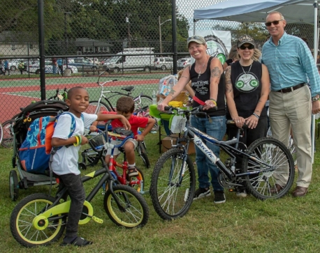 Deborah Porretto and Lisa Karrer, co-founders of Brett’s Bicycle Recycle, talked with Assemblymen Steve Stern, far right, about the non-profit during Huntington Awareness Day. Photo: Dana E. Richter, Dana Richter Photography