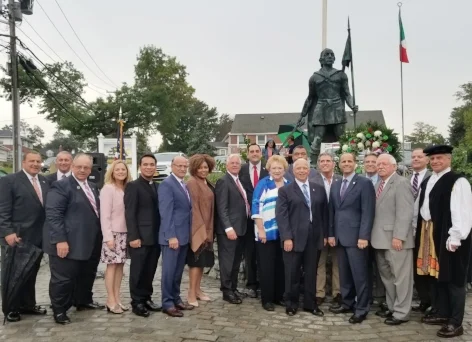 In celebration of Columbus Day, from left, Steven Rossetti, Assemblyman Steve Stern, Parade Chair Keith Wilson, Councilwoman Joan Cergol, Father Noel Sixon, past OSDIA President Joseph DiTrapani, Tax Receiver Jillian Guthman, County Comptroller John Kennedy, Supervisor Chad Lupinacci, Town Clerk Jo-Ann Raia, Legislator William Spencer, OSDIA State 1st Vice President Anthony Naccarato, Councilman Eugene Cook, OSDIA State President Robert Ferrito, Robert Fonti, OSDIA National Treasurer Thomas Lupo, Councilman Ed Smyth gather in front of the Columbus statue. Photo/Town of Huntington