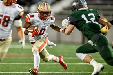Freshman running back Dakim Griffin (#20) rushing in one of his team-leading 19 attempts against Westhampton. Photo by Phil Orlando