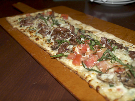  Roasted veggie flatbread ($12.49) with fresh spinach and artichoke sauce, tomato, mushroom, balsamic onions, and a mozzarella and provolone cheese blend.   Long Islander News photos/Sophia Ricco  