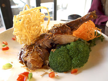  Tamarind Honey Duck ($24.94) is plated with broccoli and crispy noodle. 