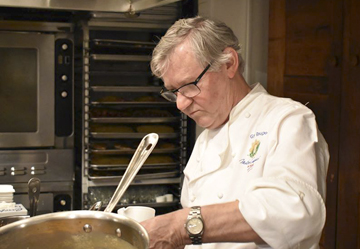 Chef Guy Reuge plates up a dish in the kitchen at Sandbar on Main Street in Cold Spring Harbor.