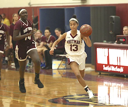 Walt Whitman senior guard Desiree Kleberg (13) dribbles past opponents.