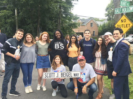 Dix Hills native Scott Beigel who lost his life trying to protect students during the Parkland shooting, was honored when the street he grew up on was dedicated to his memory. Members of March For Our Lives Long Island showed their support at the renaming ceremony.