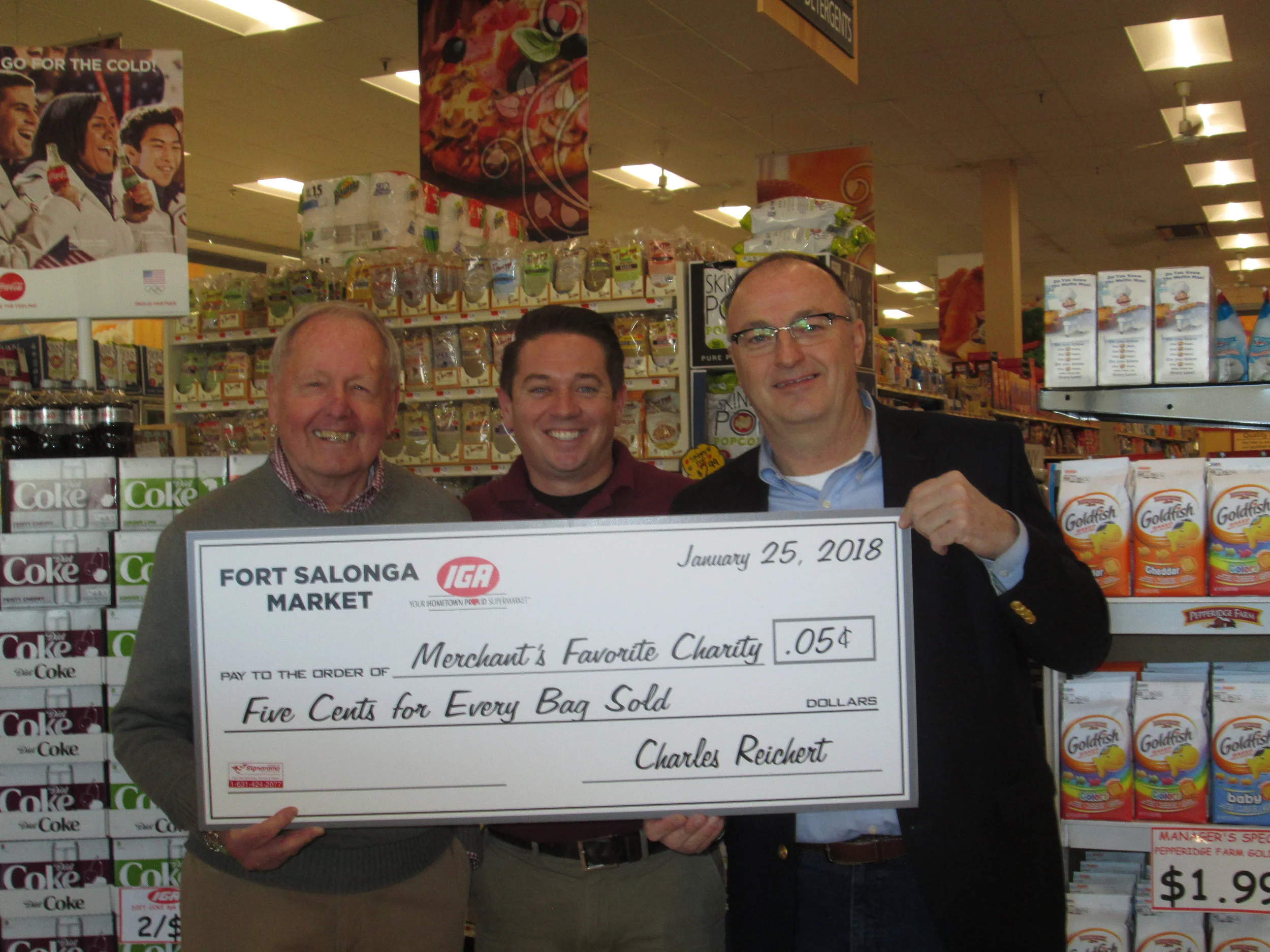 IGA owner Charlie Reichert, left, Suffolk Legislator Robert Trotta, right, and Fort Salonga IGA’s manager Ryan Ceriello pictured last year when Reichert announced he would donate the store’s plastic bag fees to Huntington Hospital.