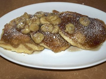  La Piazza’s thick and fluffy pancakes are topped with bananas and powdered sugar   