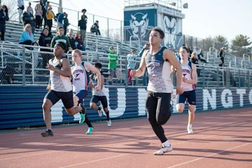 Jason Turner, right, on his way to victory for Huntington. Turner won the 100m and 200m dashes and the 4x100m relay against Smithtown West