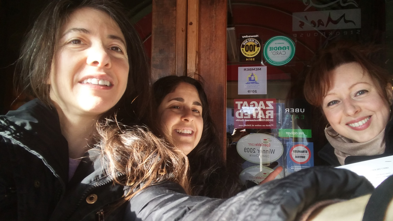 Beth Fiteni, Heidi Cohen and Tara Marie Kotliar of Green Inside and Out show off the Strawless Suffolk door decal at Mac’s Steakhouse in Huntington village. Photo/Green Inside and Out