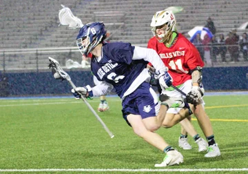 Liam Hasset avoids a check on his way to two goals and an assist for the Blue Devils. Photo/Erik Krisch