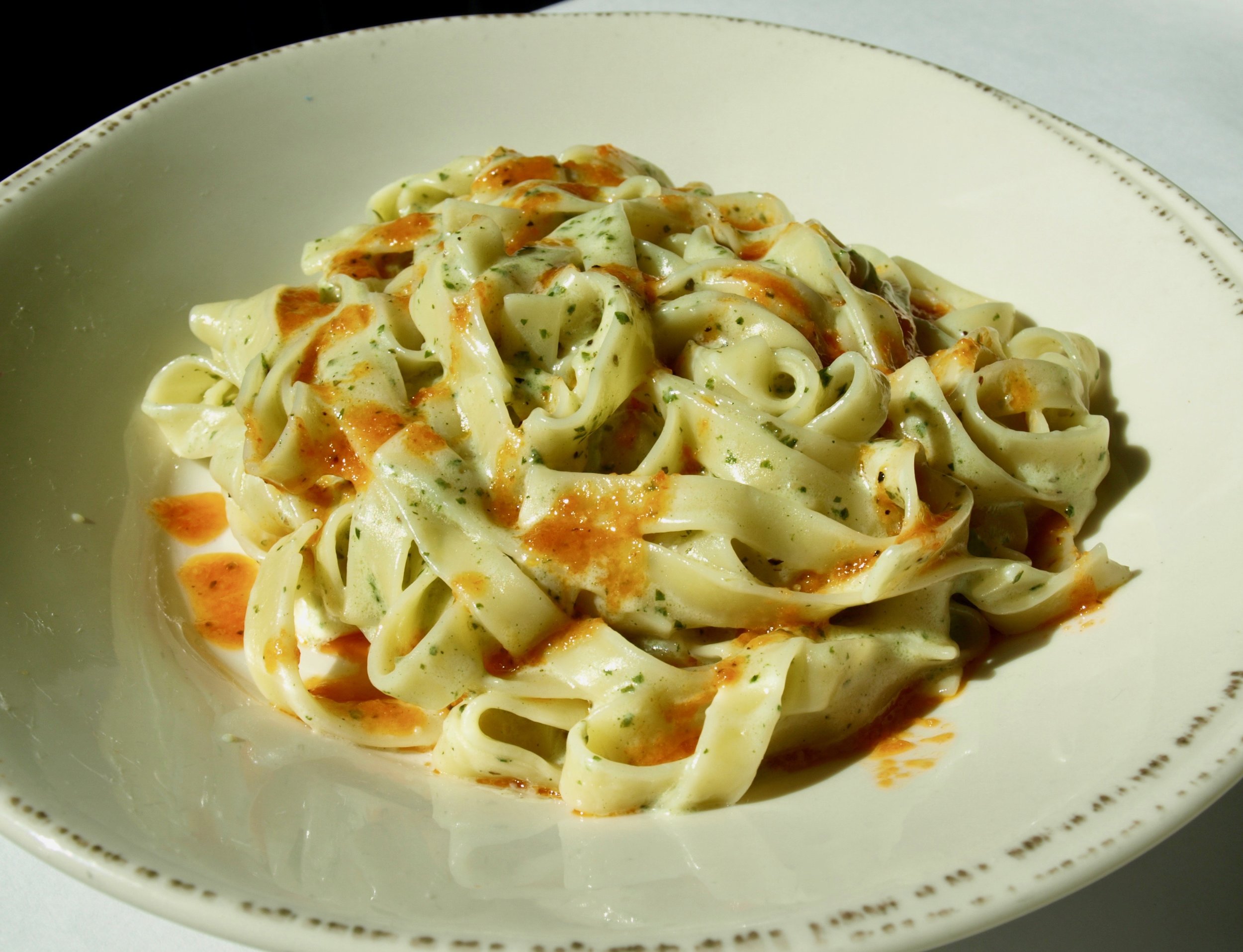   Tagliatelle pasta with roasted pepper and pesto sauce   