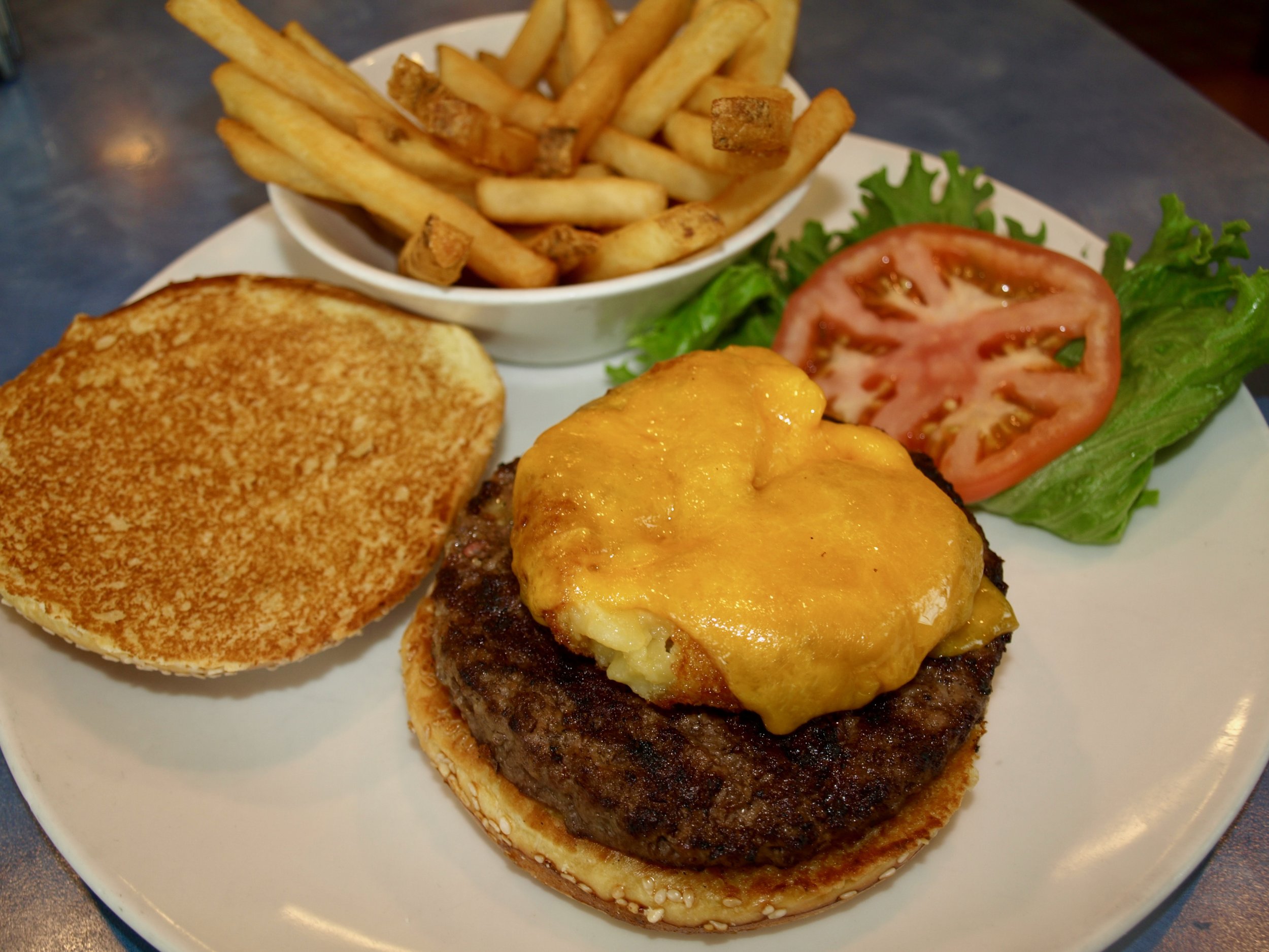  Mac and cheese cheddar cheeseburger starts with a fresh beef burger topped with fried mac and cheese bites, melted cheddar, lettuce and tomato.  Long Islander News photos/Sophia Ricco  