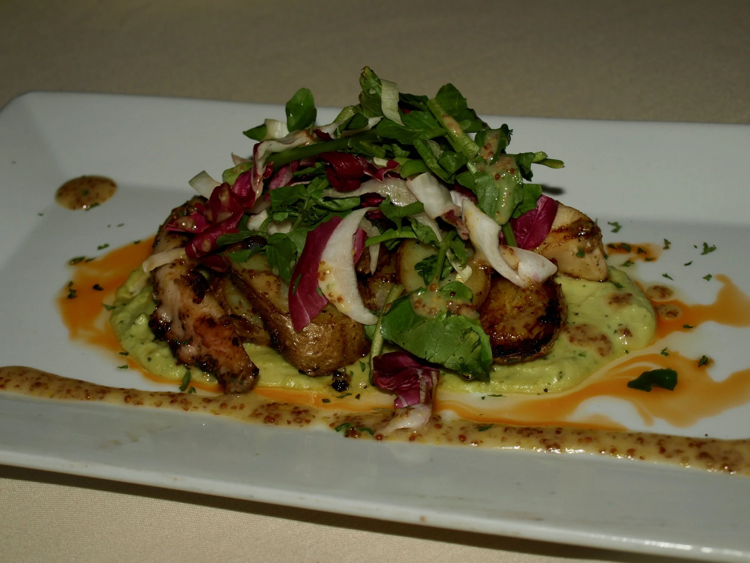   Mediterranean octopus a la plancha with potatoes, fava bean hummus, tri- color greens, stone ground mustard vinaigrette and fresh dill.  