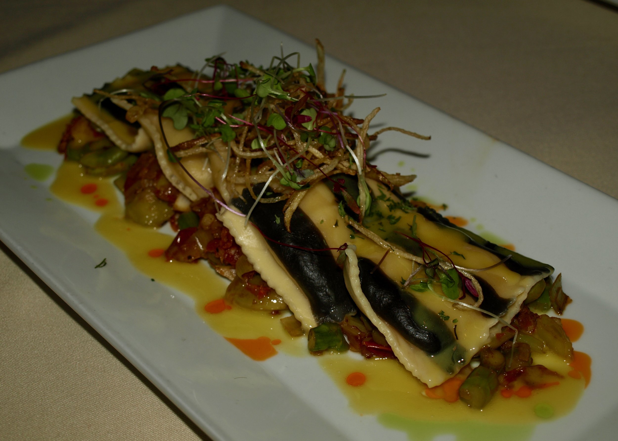  Striped Maine lobster ravioli with asparagus, leek, fennel and lobster ragout, saffron-truffle burro fuso, and haystack potatoes. 