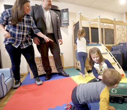 Jade and Rob Madden with the kids in their new — still clean — playroom.