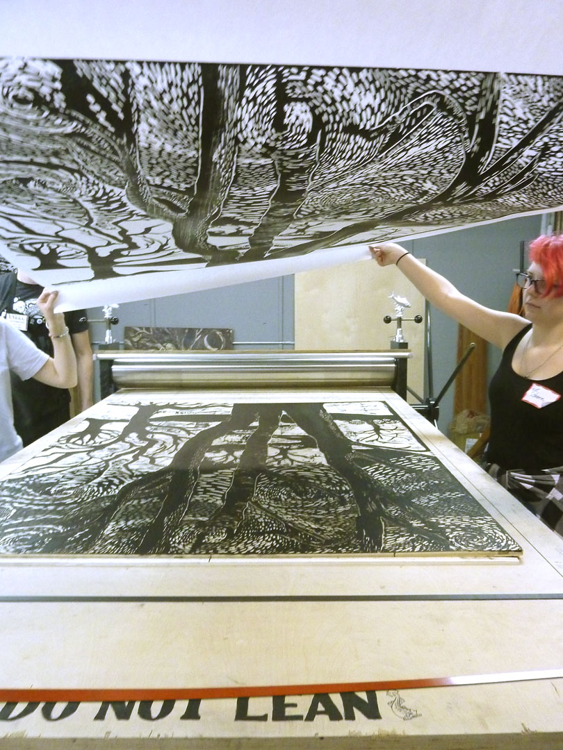   Kat Shorn gets a first look of the print coming off the press.  