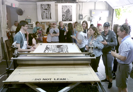   Artists gathered around the Big Ink mobile press.  