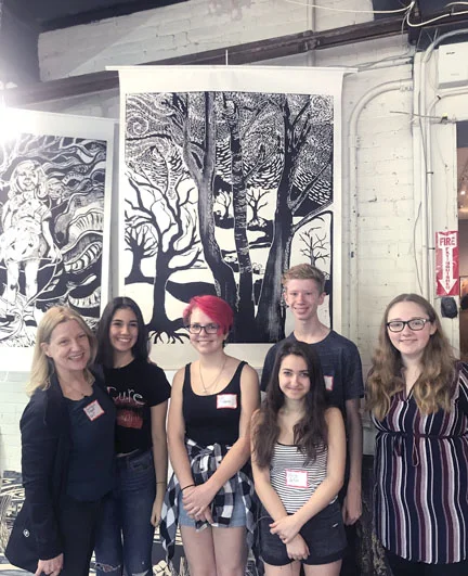   Northport High School art teacher Constance Wolf and students Emma Halperin, Kat Schorn, Eli Dalton, Olivia deFeo and Elle Vezzi in front of the students’ print of trees.  