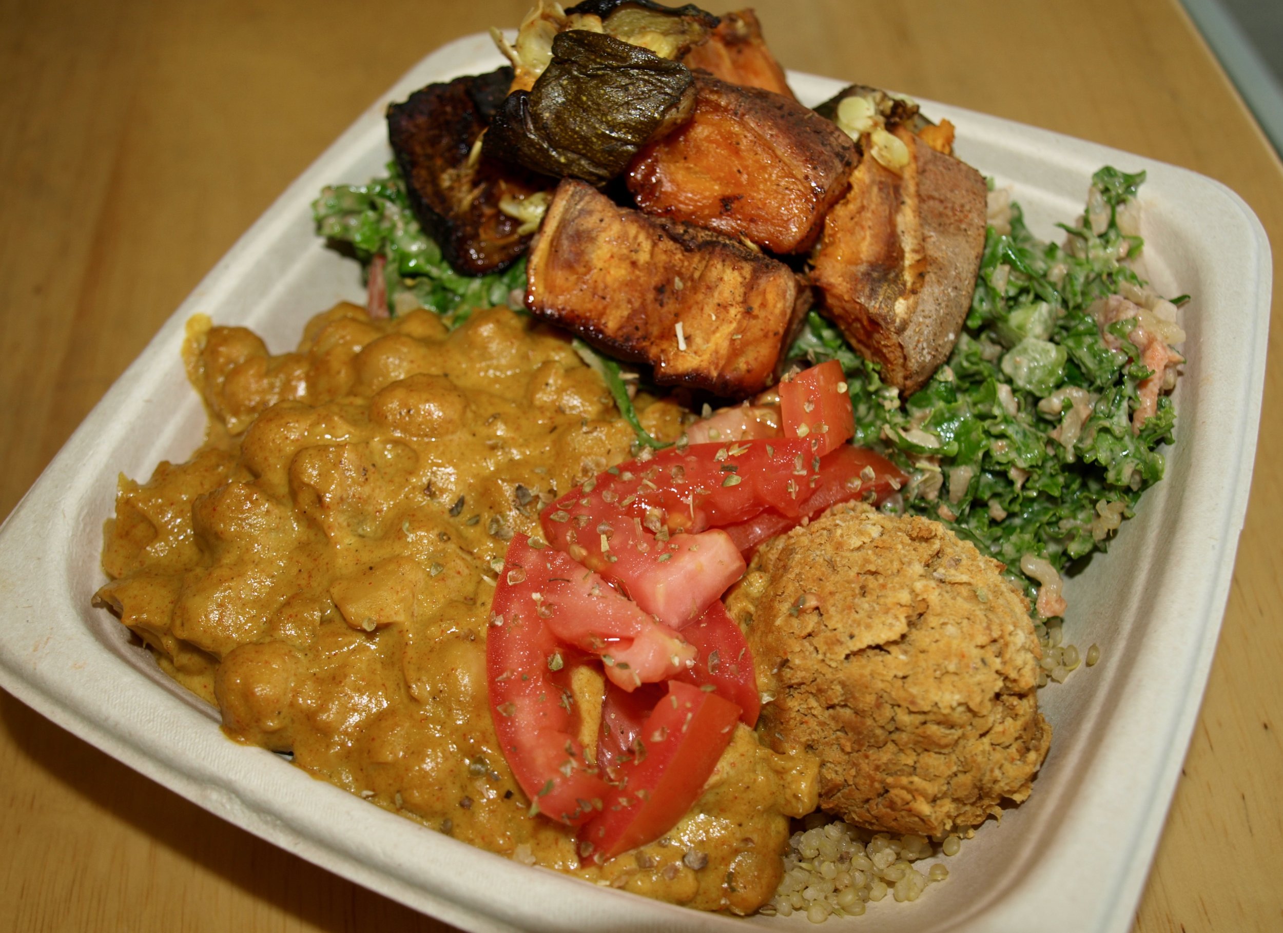   Half &amp; half of Southern charm (kale, cilantro, brown rice, tomato, red onion, carrots, topped with roasted veggies, and masala bowl (chickpea masala, tomato, falafel, sunflower tahini).  