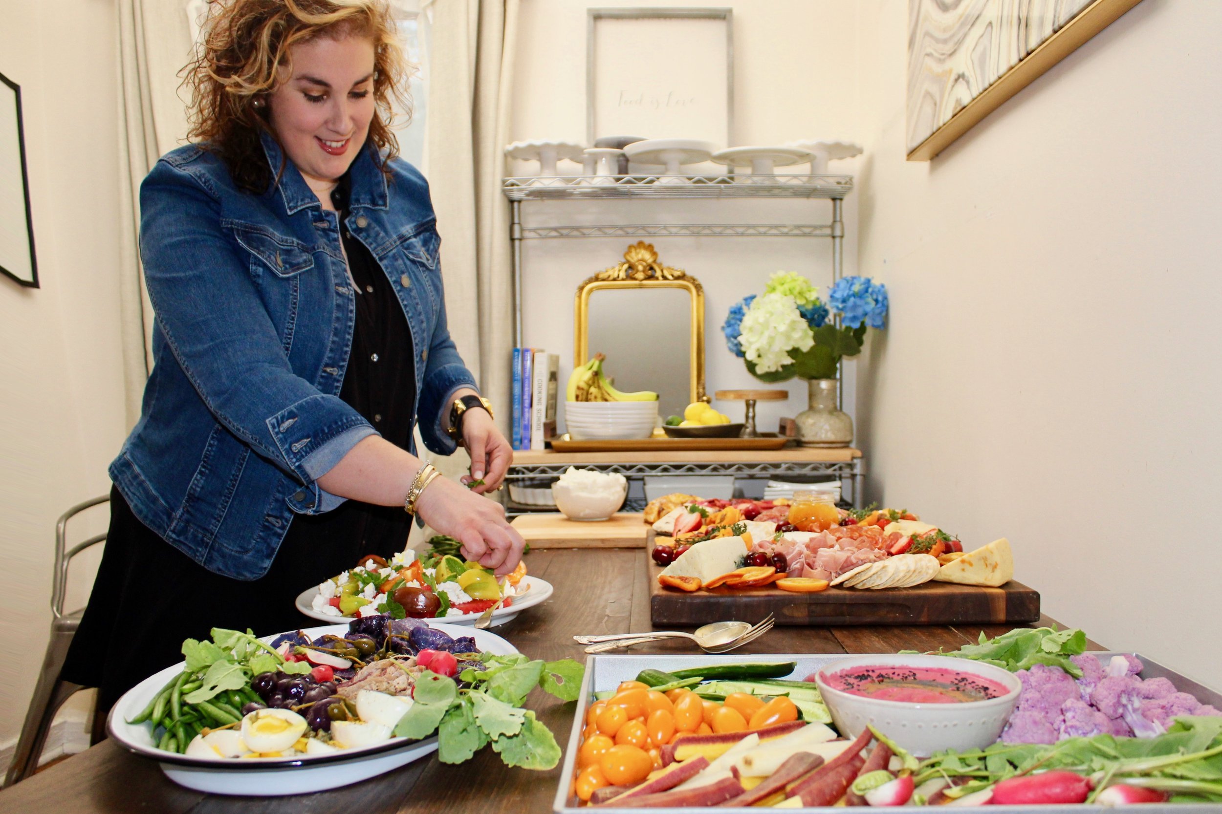  Personal chef Nicole Uliano putting the finishing touches on a spread. Her presentations’ bold contrasting colors have eye appeal, and fresh ingredients and flavor combinations take care of the rest.  