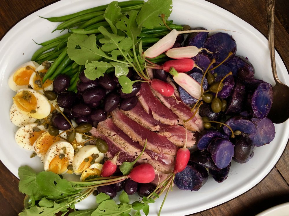   Seared tuna niçoise platter is a colorful combination of radish, string beansn potatoes and hard boiled eggs.  