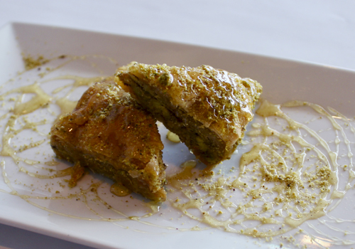  Honey-drizzled Baklava with walnut and pistachio     is topped with house dressing. 
