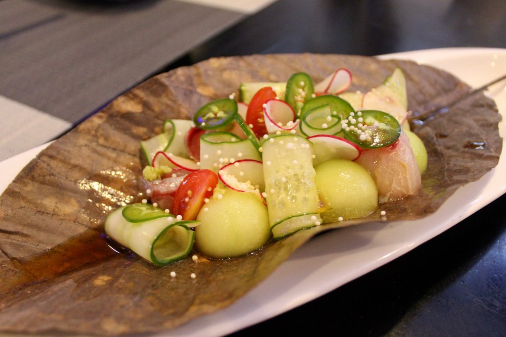  Yellowtail Jalapeno with enoki mushrooms, wasabi yuzu, cherry tomatoes and melon balls. 