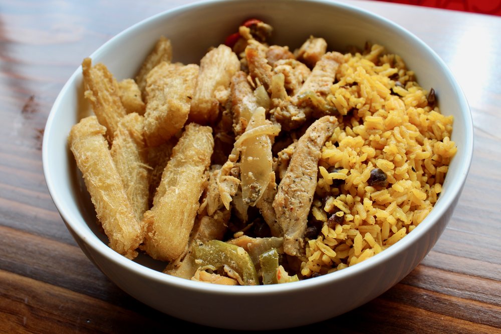  Cana bowl with grilled chicken, yellow rice and peas, and fried yucca. 