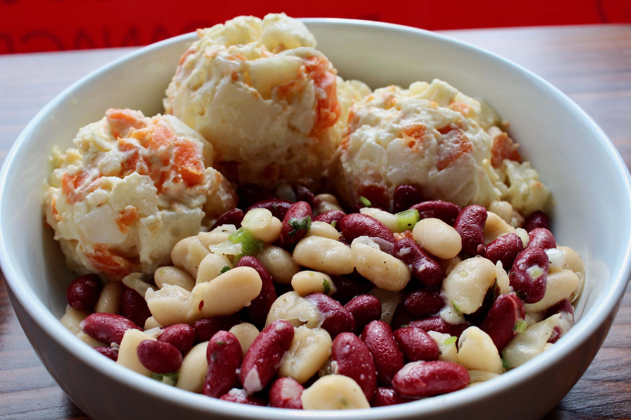  Sides of bean salad and potato salad. 