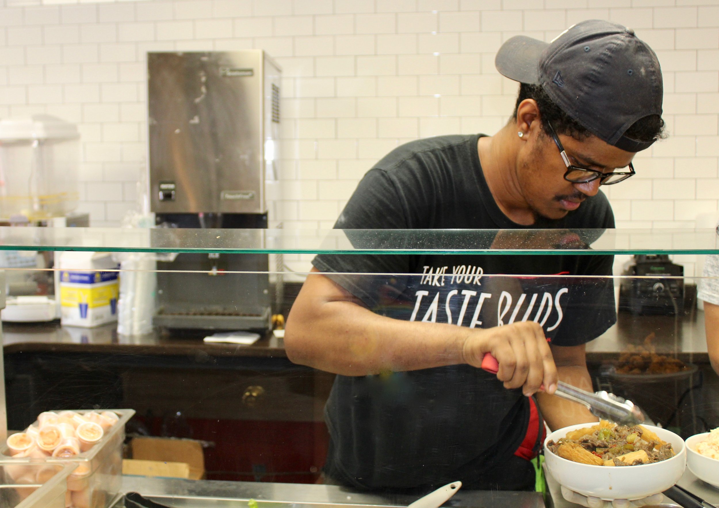  Manager George Lugo dishes out a cana bowl. 