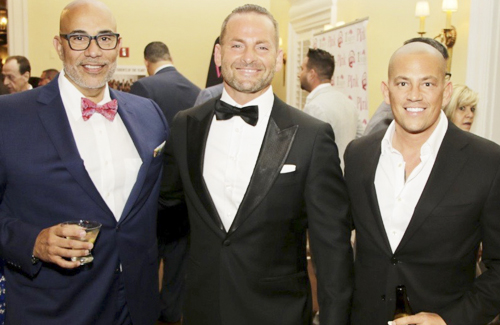 Lloyd Neck resident Asaf German’s “Racing to a Cure” event held at Ferrari Maserati of Long Island raised over $70,000. Pedro Velez, left, and Christopher Chiarenza, right, were among more than 400 guests who joined German, center, at the event.