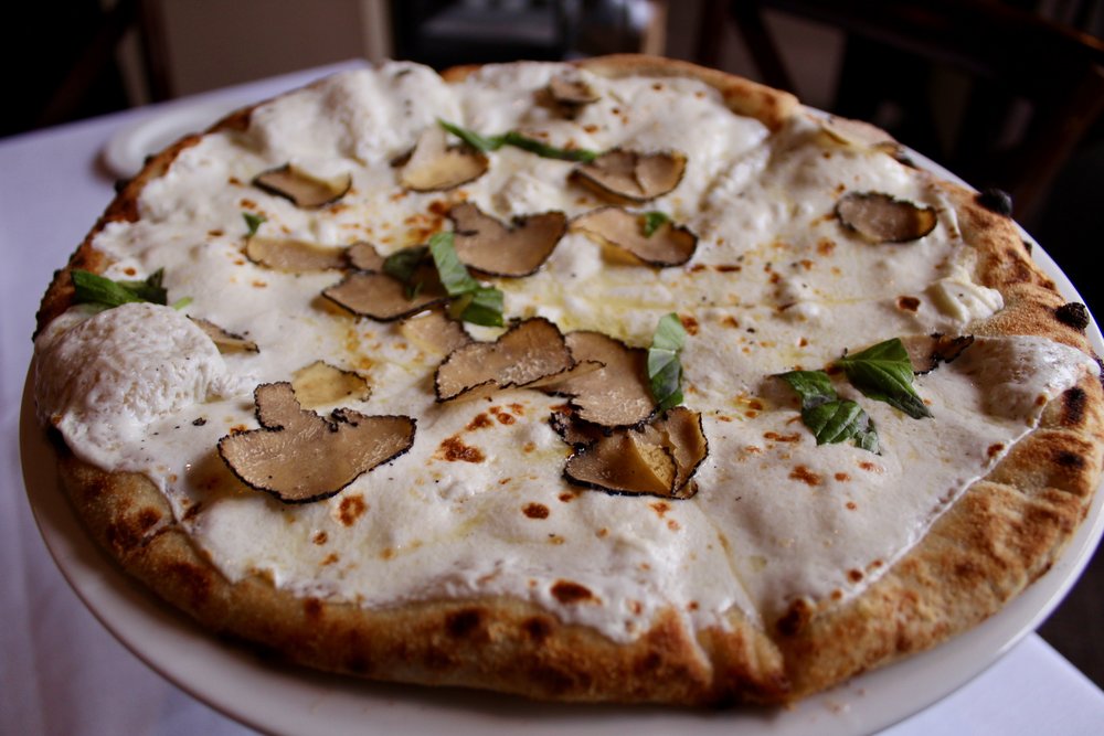  Robiola pizza is rich with the flavors of imported robiola, fresh mozzarella, basil and truffles. 