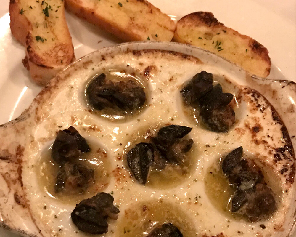  Escargot with herbed garlic butter and crostini for dipping. 