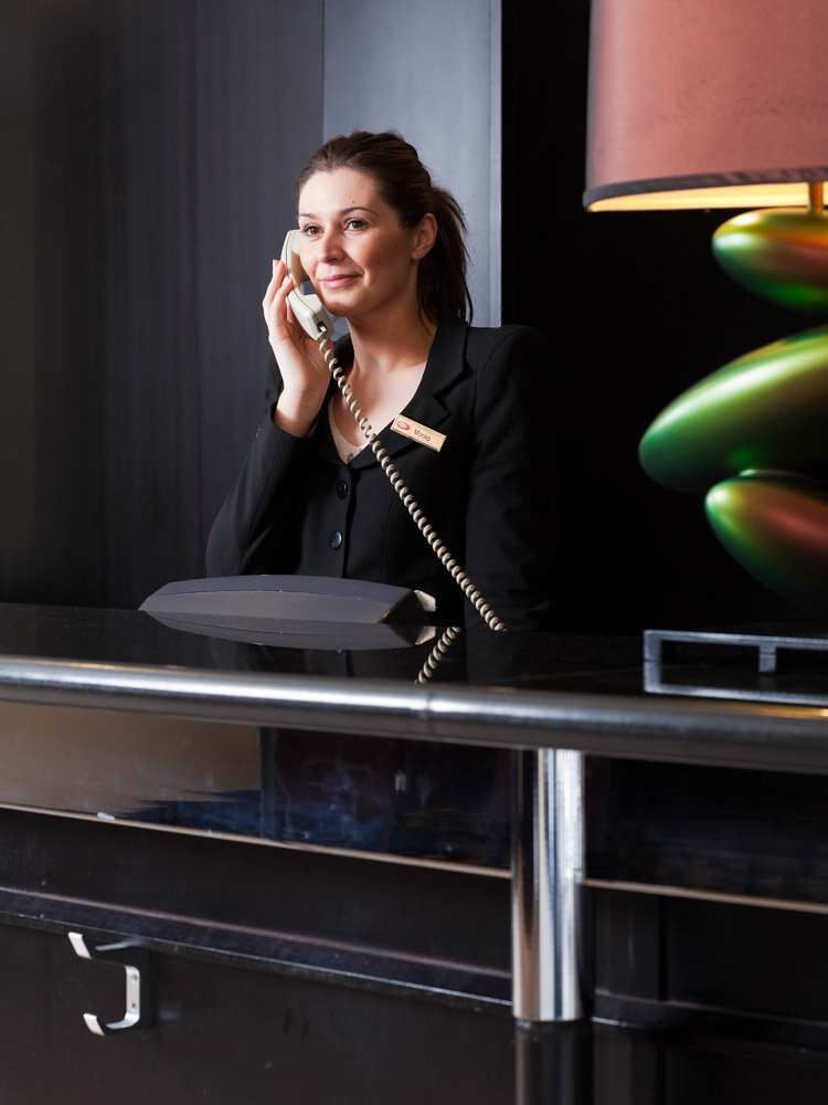 female-receptionist-on-the-phone-IHG-hotel