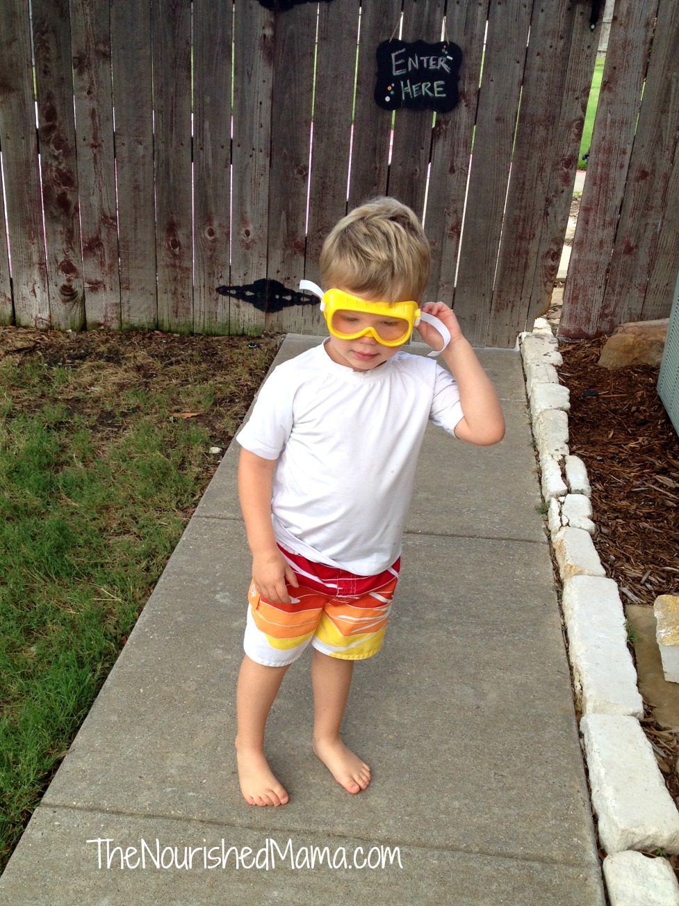 Heading to swim with his "goggles" on.