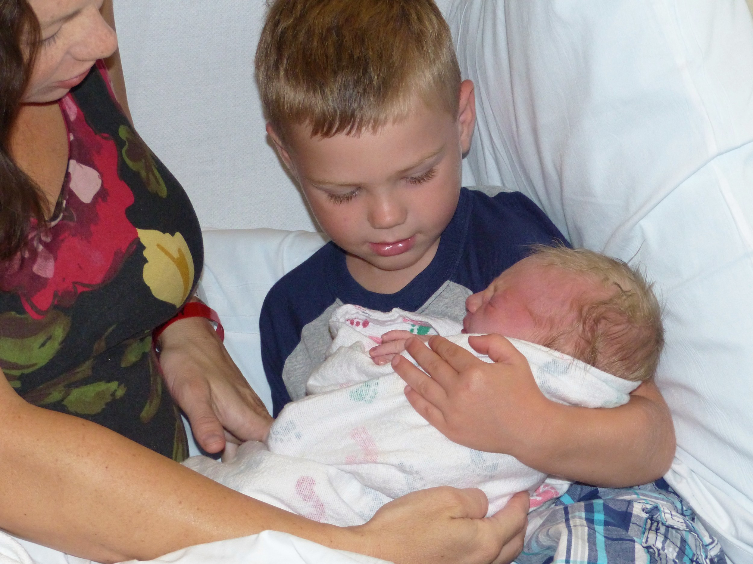 In big brother's arms. The only two people in the whole wide world who will know what growing up in their home, with their parents is like. In just a few years, they'll be saying, "Oh you know how mom is. She's soooo annoying!" :) I hope they always know how special that relationship is and pray that it's one built on love, trust, and mutual respect for each other. {~nine hours old}