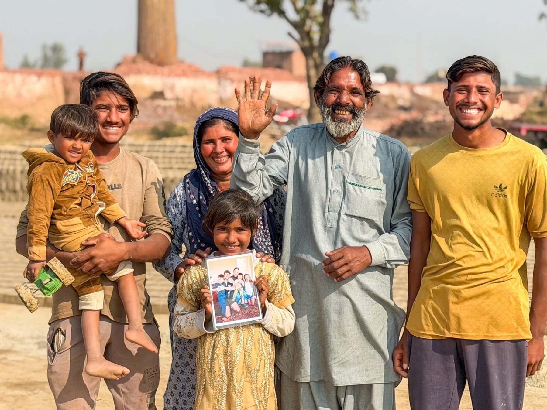 Yousaf Sohan and family holding a photograph of Grant’s family