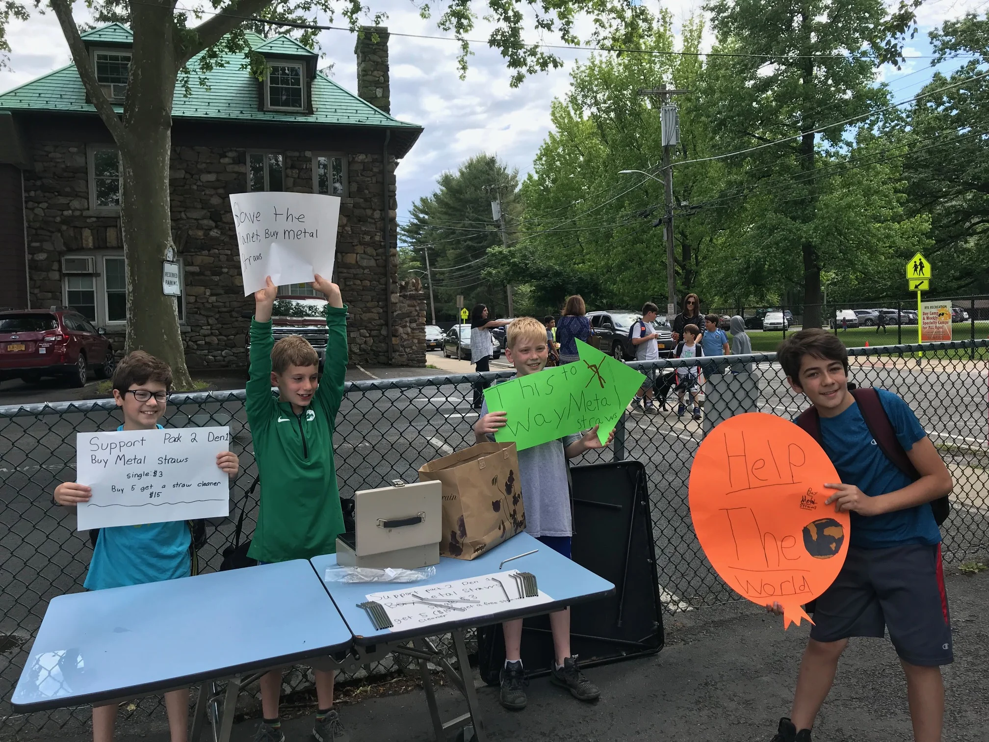 Members of Boy Scout Pack 2 Den selling metal straws at Midland Elementary School.