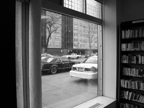 Police car on the sidewalk outside the Chicago Bee Branch Public Library.