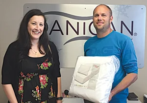 Traci Walker, Resident Services Coordinator for Housing Authority of SLO (HASLO) receives donations of Danican Care Packages from Thomas Frismodt, CEO of Danican.